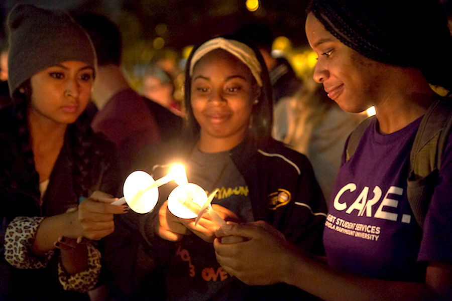 Three students at candlelight vigil