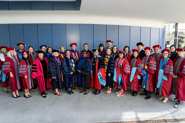 All of the SOE doctoral graduates in their cap and gowns after being hooded