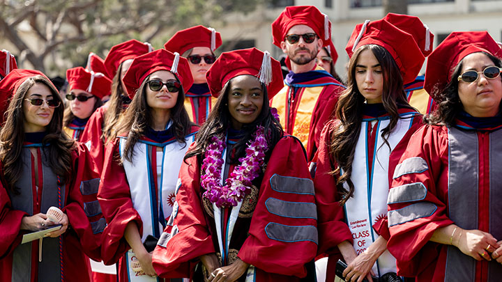 A group of graduate students paying attention during the commencement ceremony