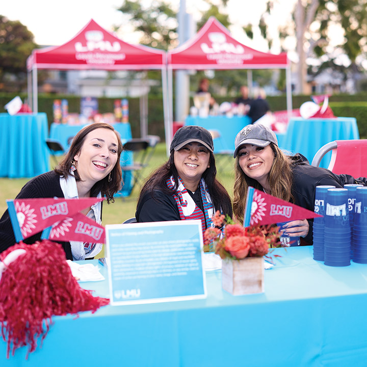 Three People decked out in LMU Clothing and Swag